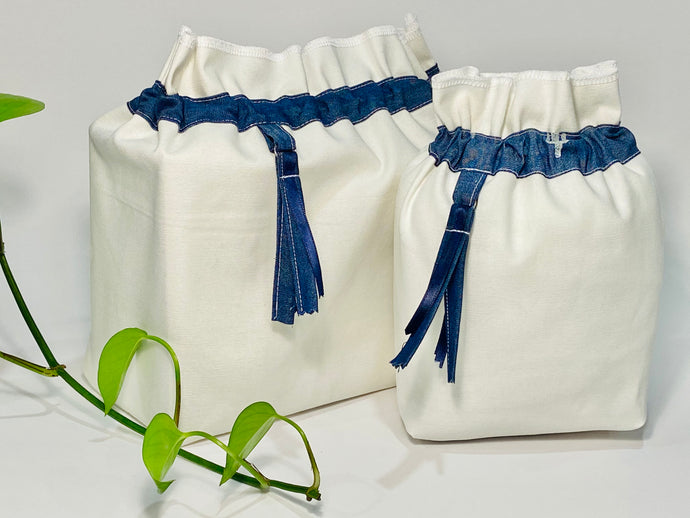 Two bags in off-white cotton with a Blue Denim trim. One bag is big and one small.