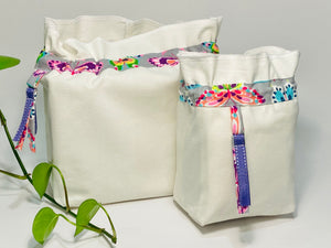 Two bags in off-white cotton with a Butterfly trim. One bag is big and one small.