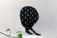 Load image into Gallery viewer, Back view of Scrub Cap with White Flamingo print on Black ground
