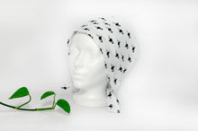 Load image into Gallery viewer, Semi Left view of Scrub Cap with Black Flamingo print on White ground
