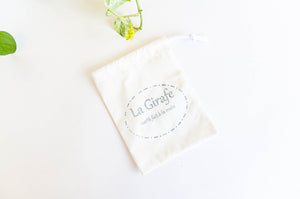 Ivory pouch printed with La Girafe logo