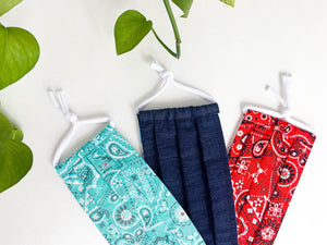 Closeup ofThree face mask, one Denim fabric, one Red Paisley print and one Aqua Paisley print