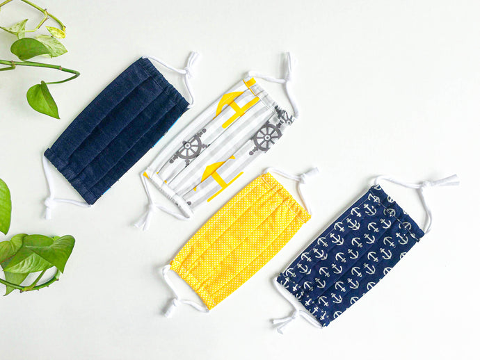 Four face mask with various Navy and Yellow prints and colours