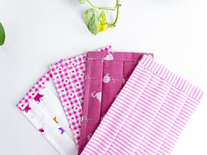 Closeup of Four Pink face mask one Princess one Flowers one Flamingo one Stripes