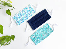 Load image into Gallery viewer, Three face masks one in denim fabric, one in Aqua paisley print and one in aqua motif print
