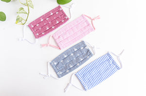 four face masks one Blue Stripes one Grey Famingo one Pink Stripes one Pink Flamingo